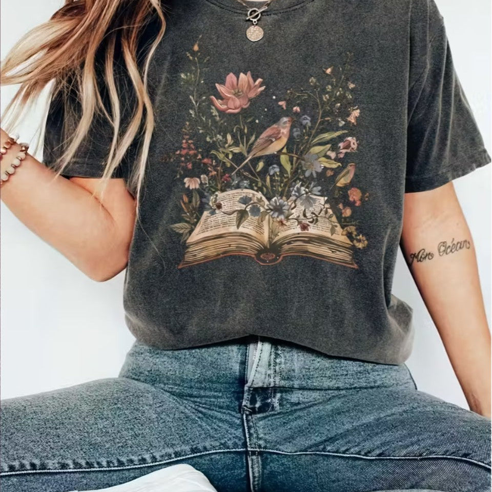 Soft eco-friendly tee with flower & book art. Ethically made in dark grey, fits UK sizes 6–18. A boho shirt for readers, writers, and wild souls.