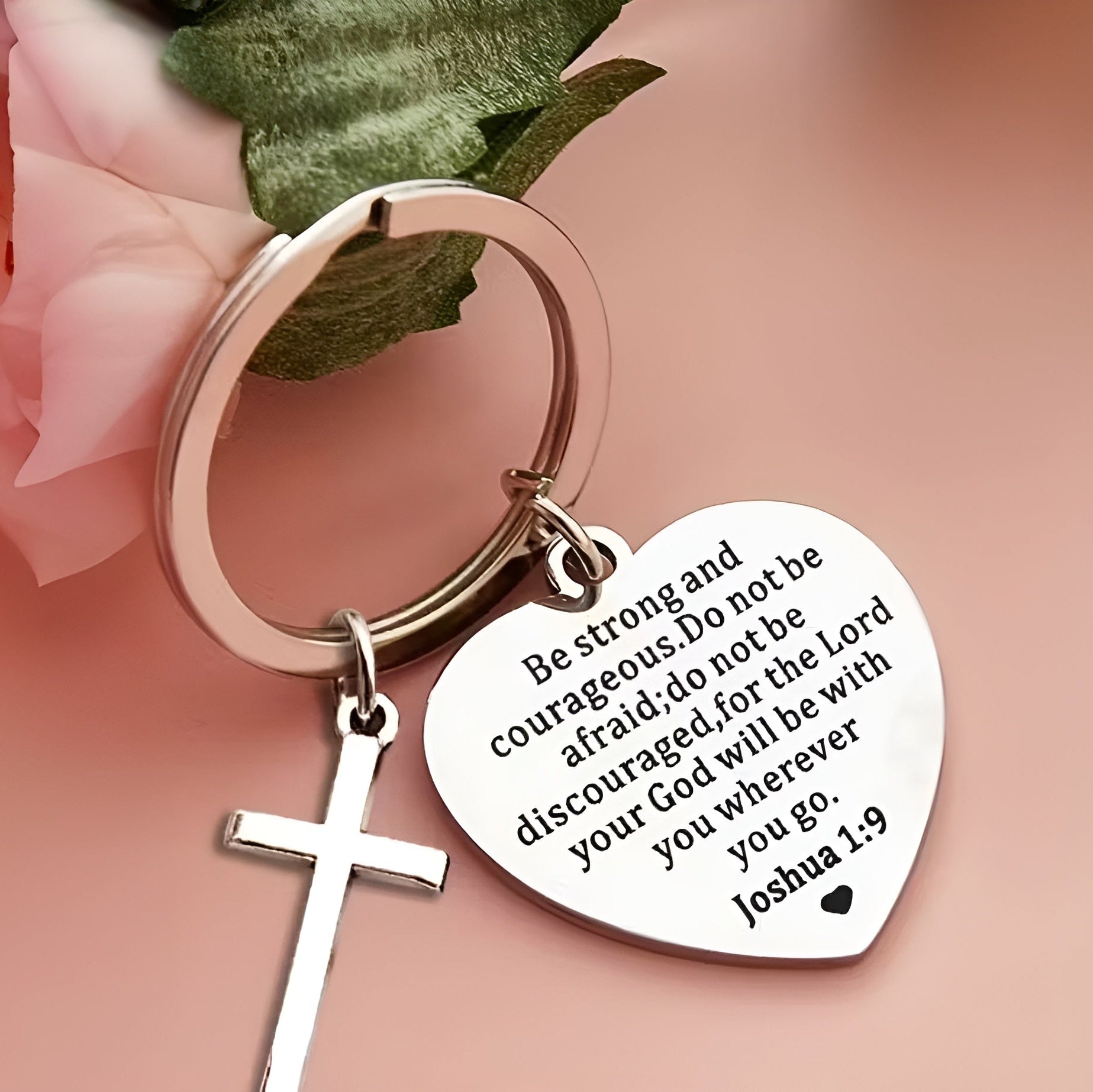 Faith Keychain with heart-shaped tag and cross charm on a soft pink background.