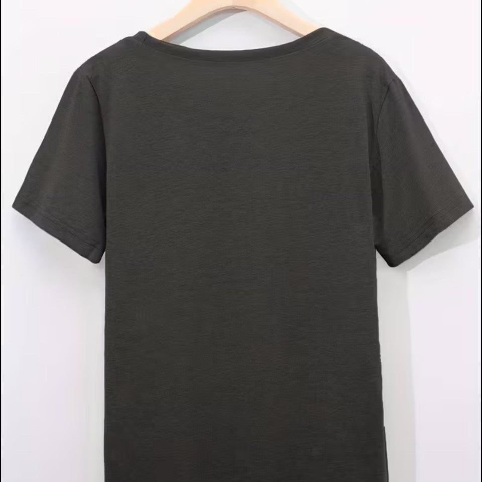 grey spiritual t-shirt on a hanger against a white background