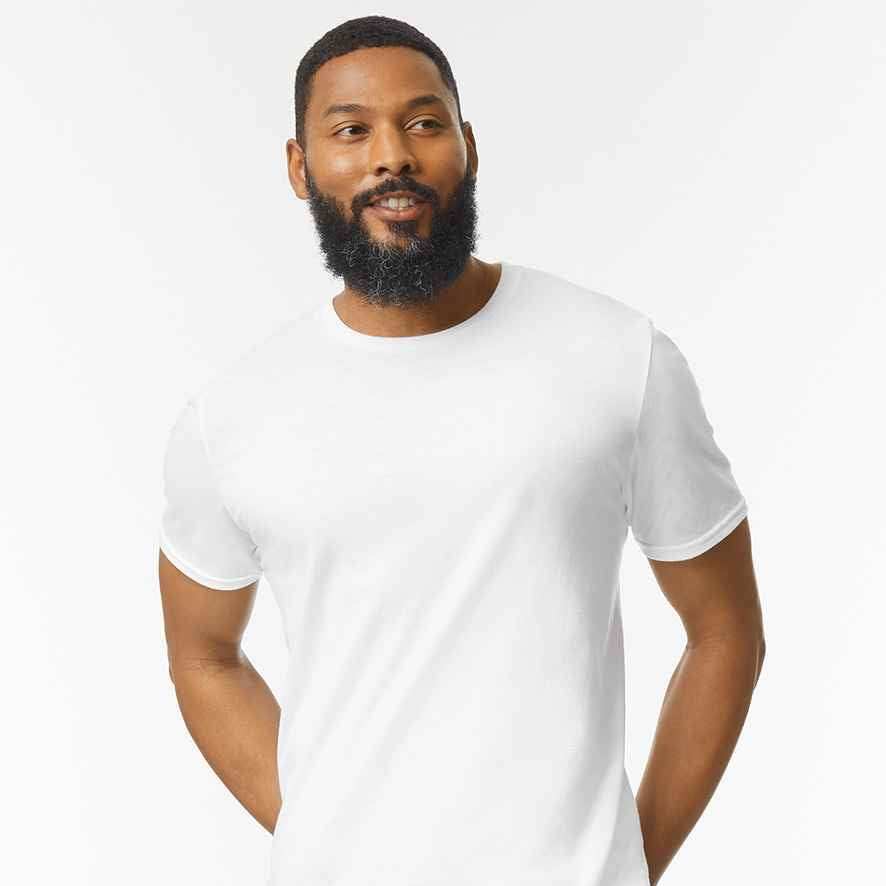 Man wearing a plain white t-shirt against a light gray background
