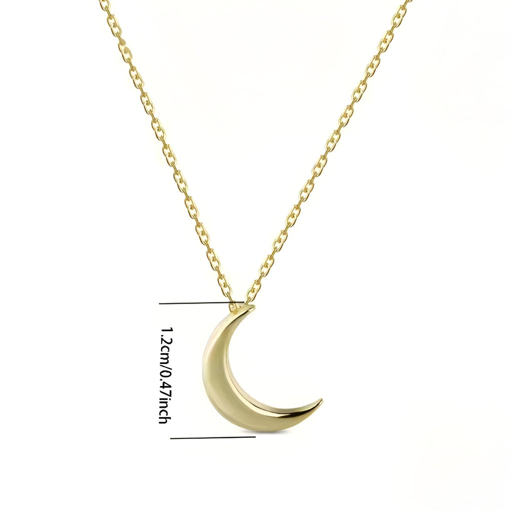 Gold crescent moon necklace with chain on a white background