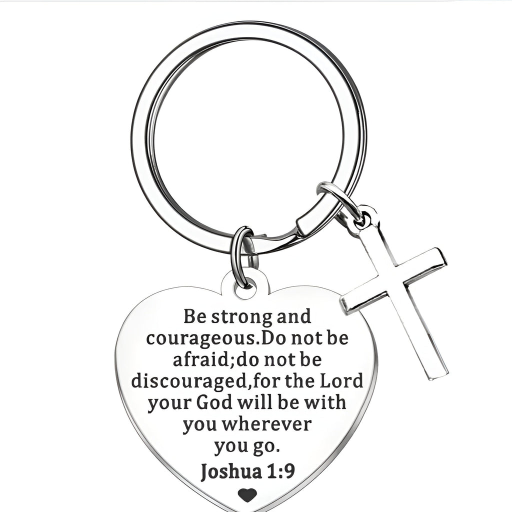 Heart-shaped Christian keychain with cross and inspirational bible quote on a white background. 