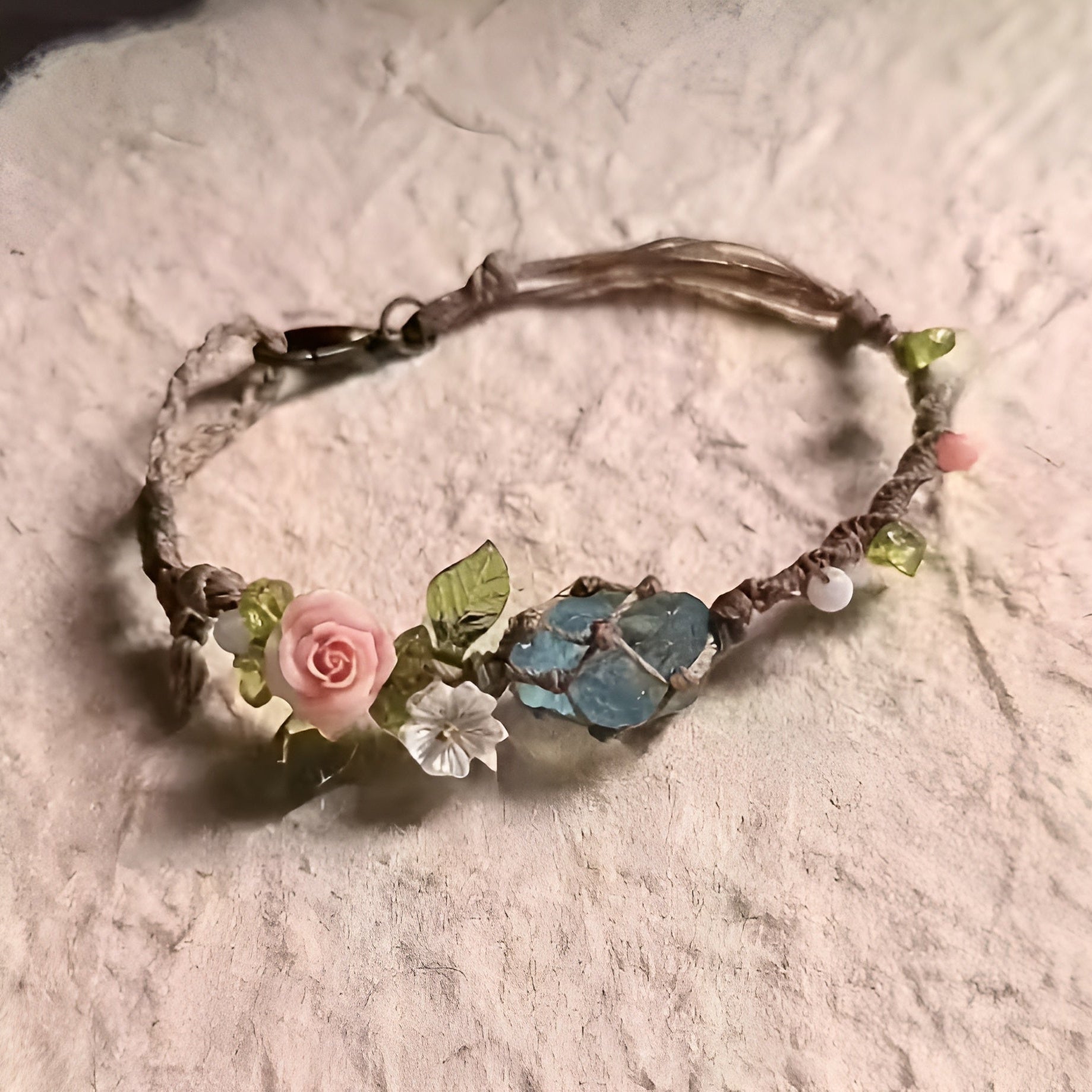 Bohemian Bracelet with floral and stone decorations on a textured surface