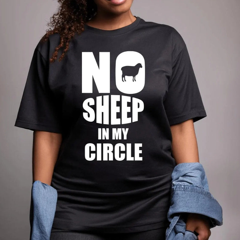 Person wearing a black t-shirt with 'No Sheep in My Circle' text and graphic on a gray background