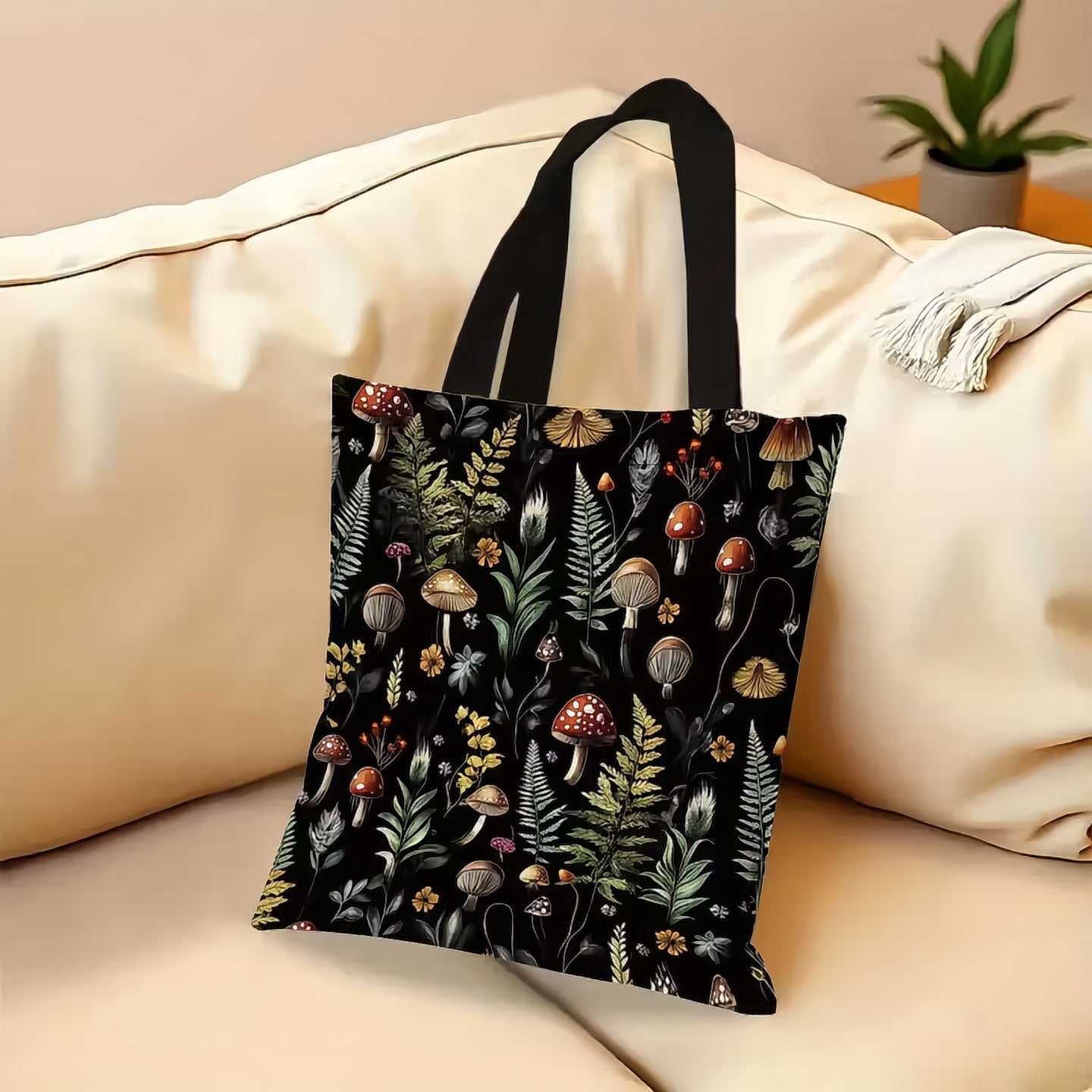 Tote bag with nature-themed design on a beige couch