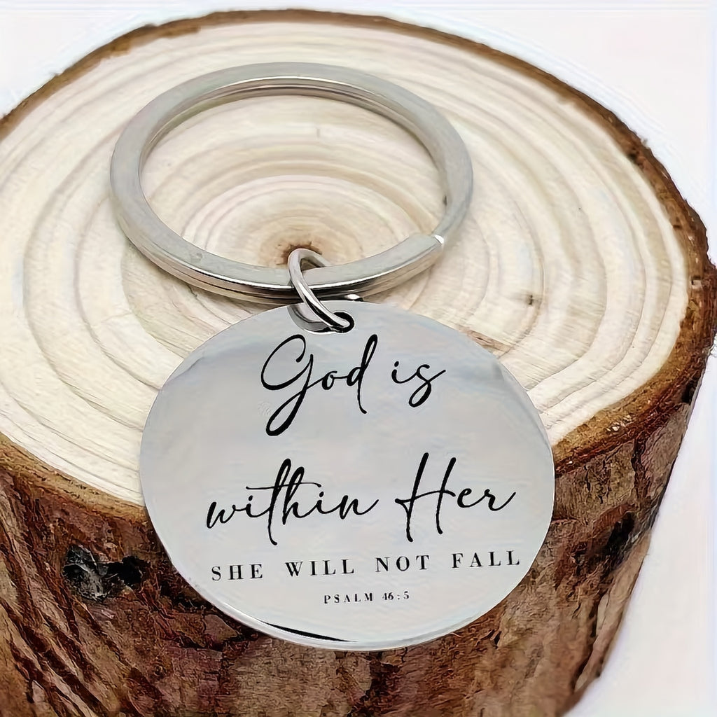 Keychain with 'God is within her, she will not fall' quote on a wooden background