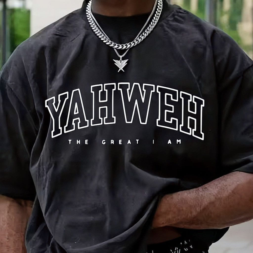 Person wearing a black t-shirt with 'YAHWEH THE GREAT I AM' text, standing outdoors.
